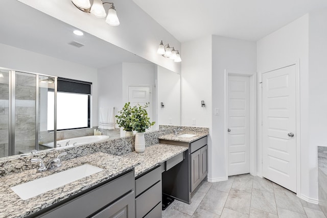 bathroom with vanity and shower with separate bathtub