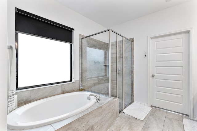 bathroom with tile patterned floors and independent shower and bath