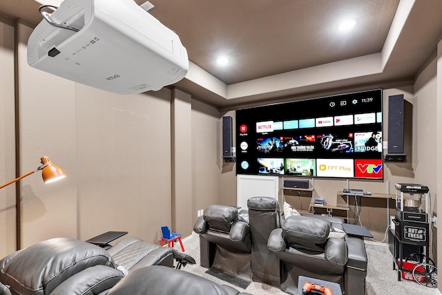 home theater featuring a tray ceiling and carpet