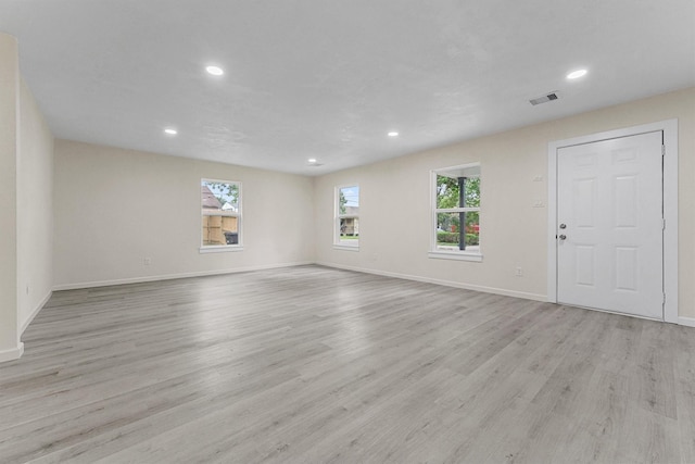 interior space with a wealth of natural light and light hardwood / wood-style flooring