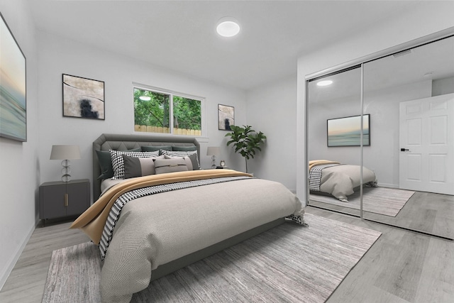 bedroom featuring light wood-type flooring and a closet