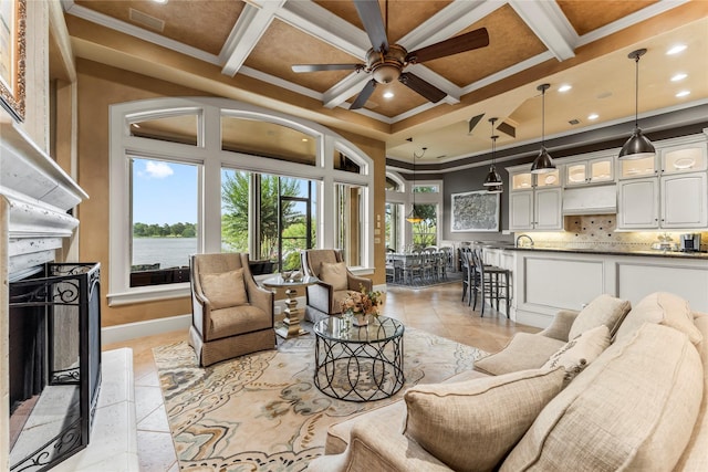 living room with beamed ceiling, ornamental molding, and coffered ceiling