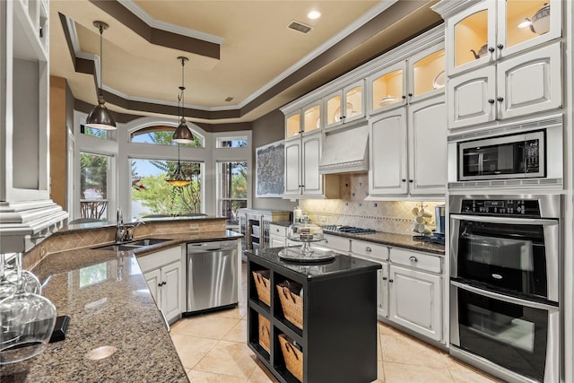 kitchen featuring light tile patterned flooring, sink, white cabinetry, dark stone countertops, and stainless steel appliances