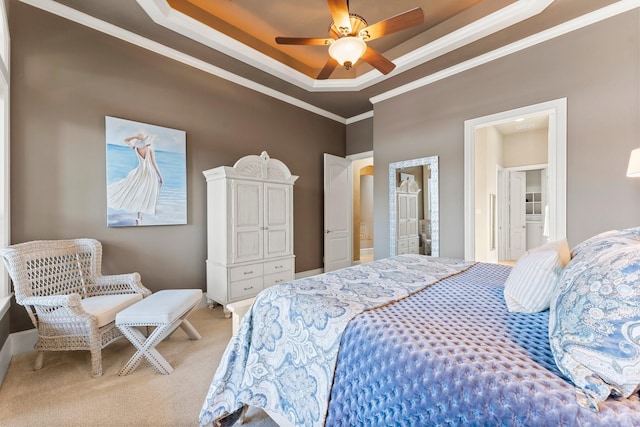 bedroom with carpet floors, ceiling fan, a raised ceiling, crown molding, and ensuite bath