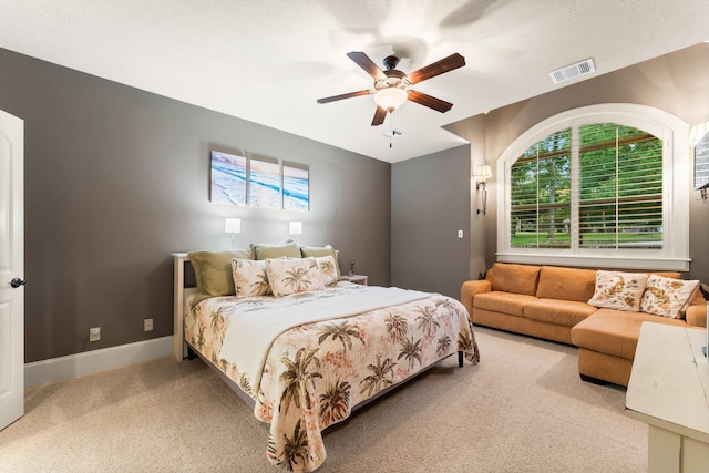 bedroom with ceiling fan and light colored carpet