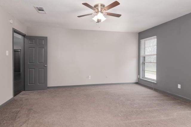 empty room with carpet and ceiling fan