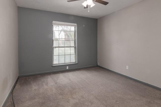 unfurnished room with ceiling fan and carpet