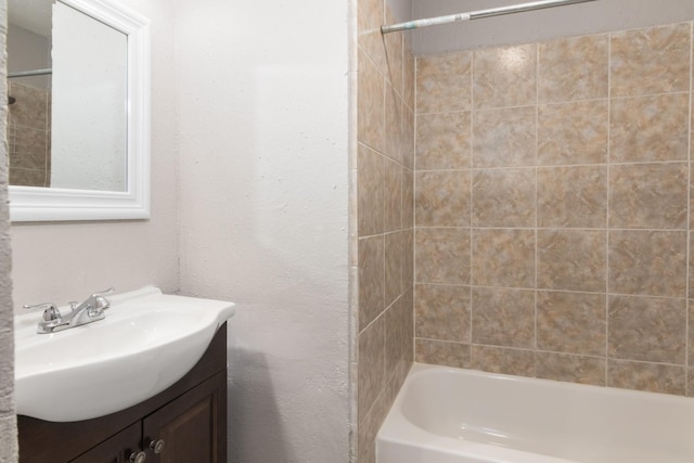 bathroom featuring vanity and tiled shower / bath combo