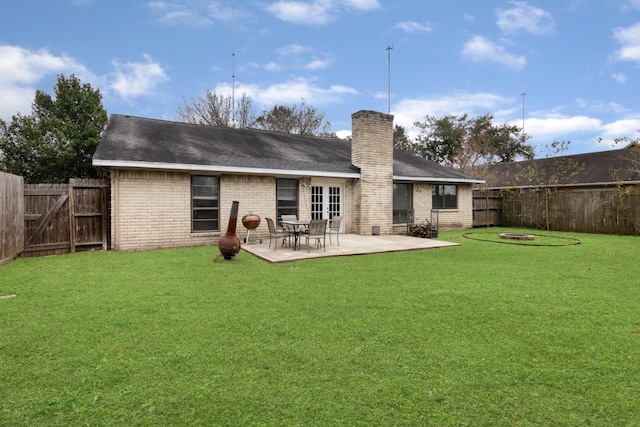 rear view of house with a patio area and a yard