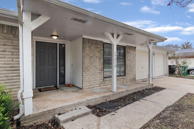 entrance to property with a porch and a garage