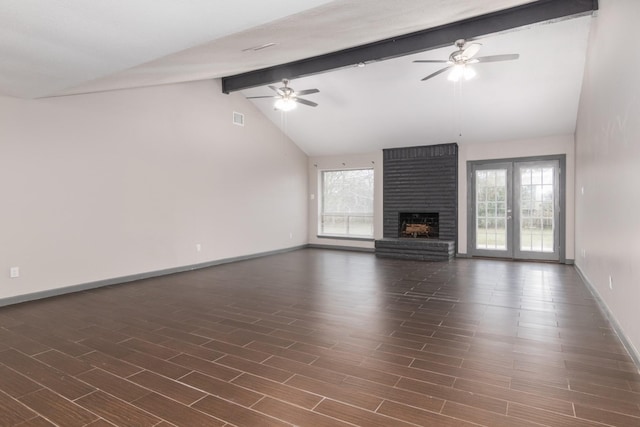 unfurnished living room with beam ceiling, ceiling fan, french doors, and a healthy amount of sunlight