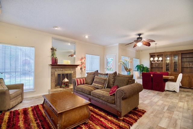 living room featuring a fireplace, crown molding, and light hardwood / wood-style flooring