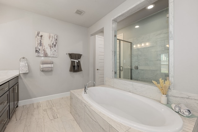 bathroom featuring vanity and shower with separate bathtub