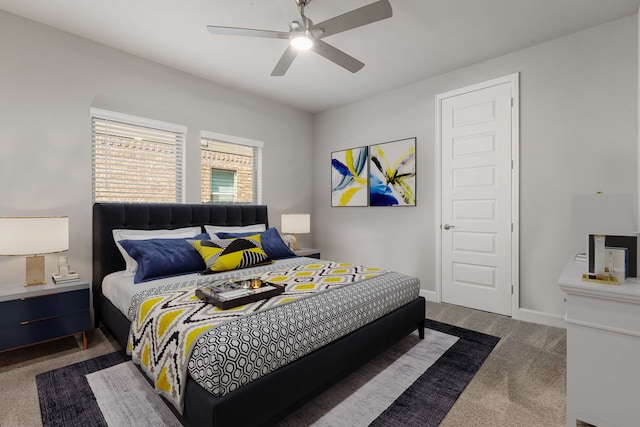 bedroom with ceiling fan and dark carpet