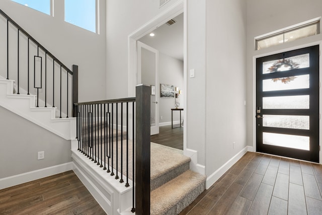 foyer entrance with a towering ceiling