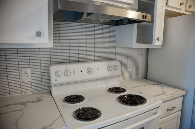 kitchen featuring white electric range oven, white cabinets, light stone counters, and wall chimney exhaust hood