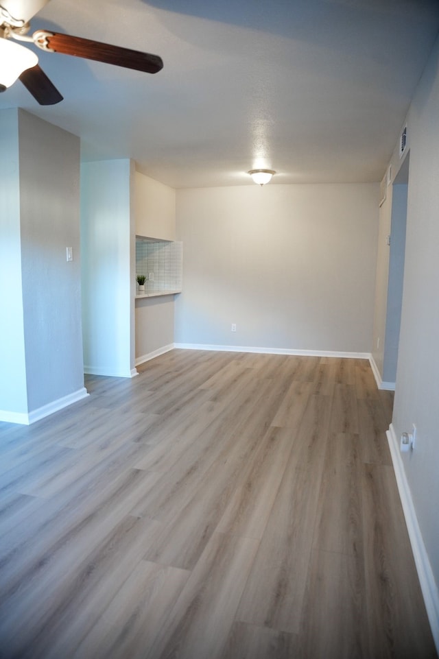 empty room with ceiling fan and wood-type flooring