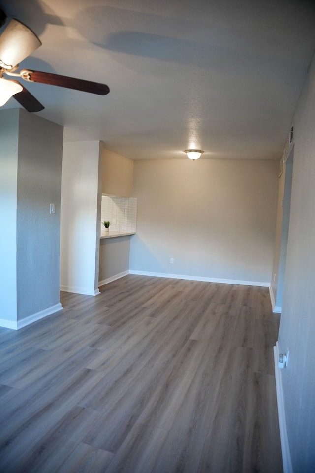 unfurnished living room with ceiling fan and wood-type flooring