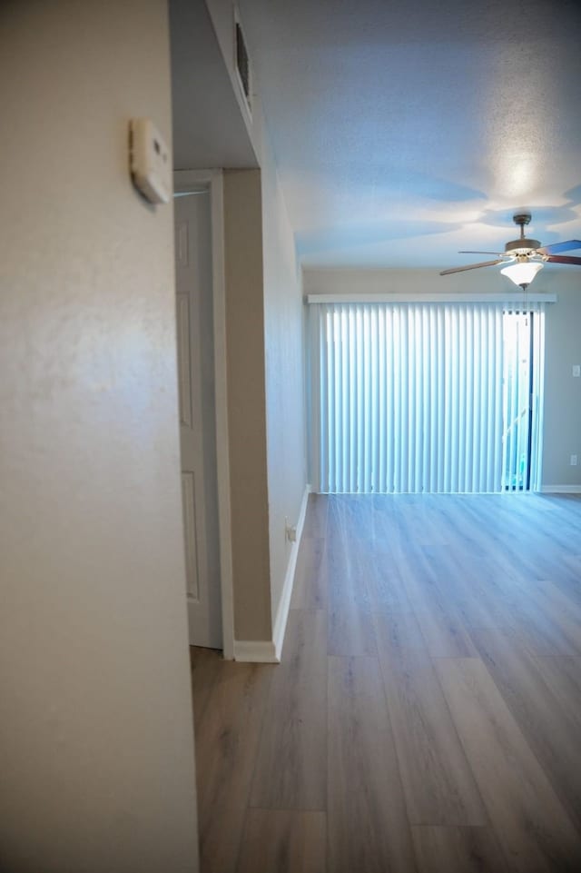 hall featuring hardwood / wood-style floors and a textured ceiling