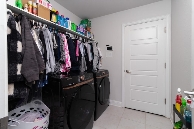 laundry area with washer and dryer and light tile patterned flooring