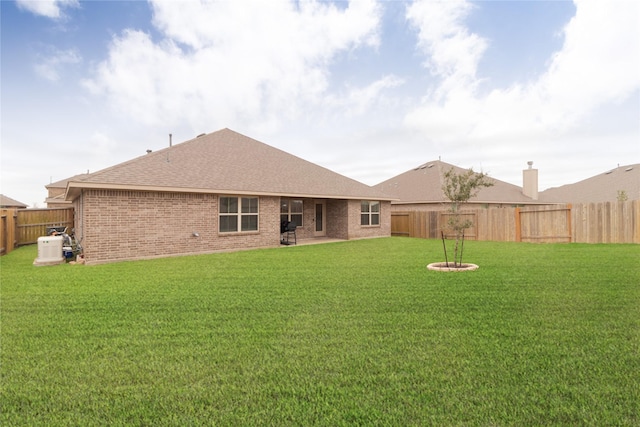 rear view of property featuring a lawn