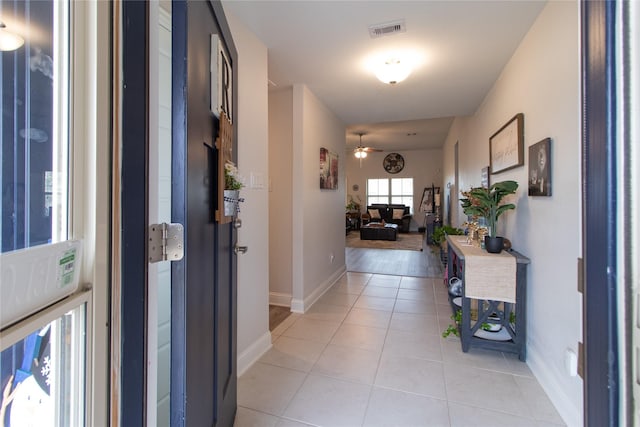 hallway featuring light tile patterned floors