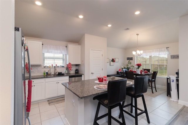 kitchen featuring a center island, sink, white cabinets, and appliances with stainless steel finishes