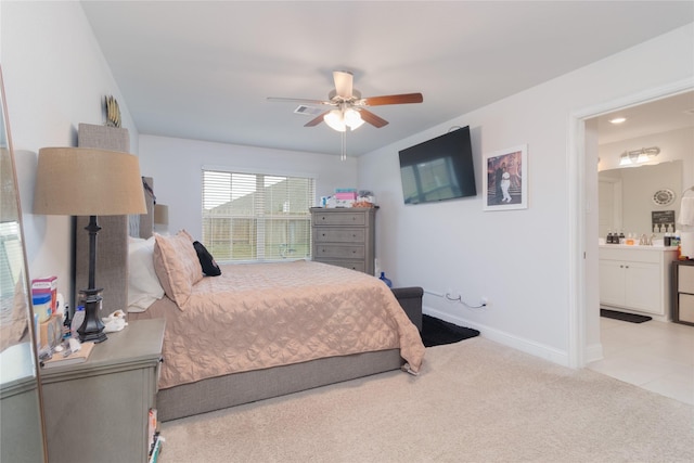 carpeted bedroom featuring connected bathroom and ceiling fan