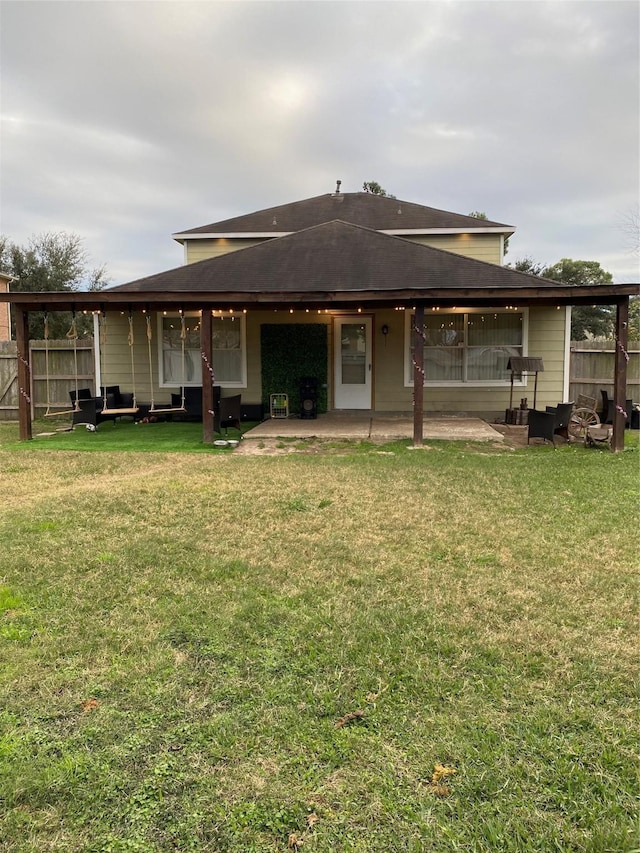 back of property featuring a yard and a patio