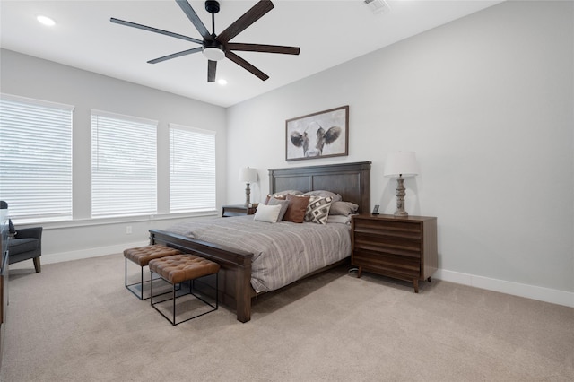 bedroom with ceiling fan and light colored carpet