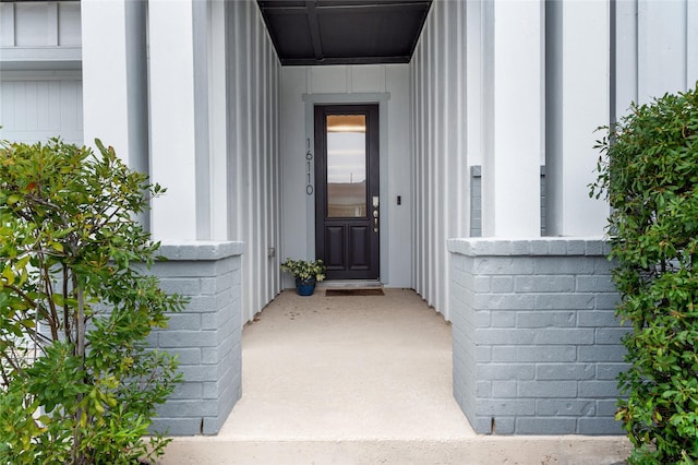 doorway to property with brick siding