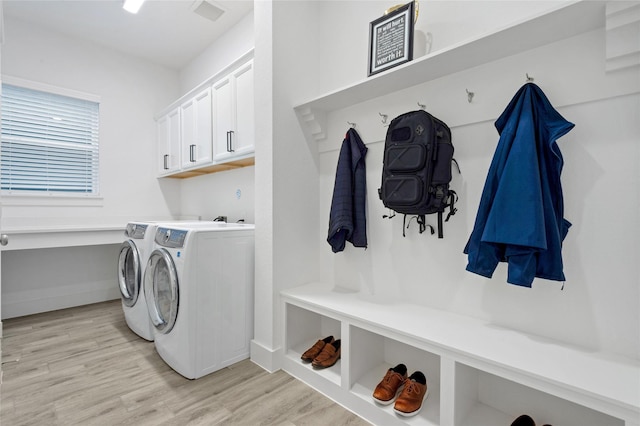 laundry area with cabinet space, baseboards, visible vents, washer and dryer, and light wood-type flooring