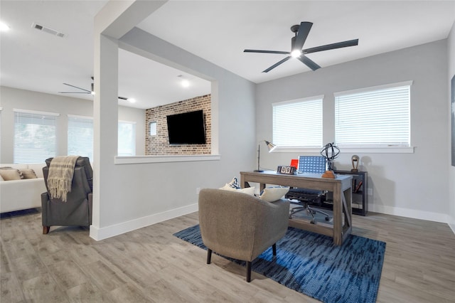 office with a healthy amount of sunlight, light wood-style flooring, visible vents, and a ceiling fan