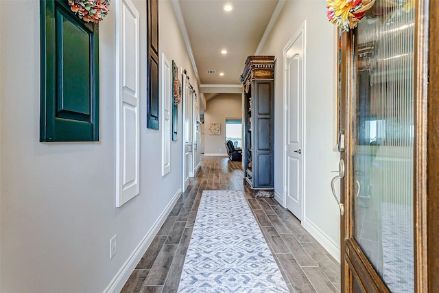 hallway with ornamental molding and a barn door