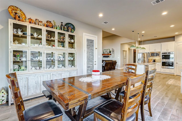 dining area featuring sink and light hardwood / wood-style flooring