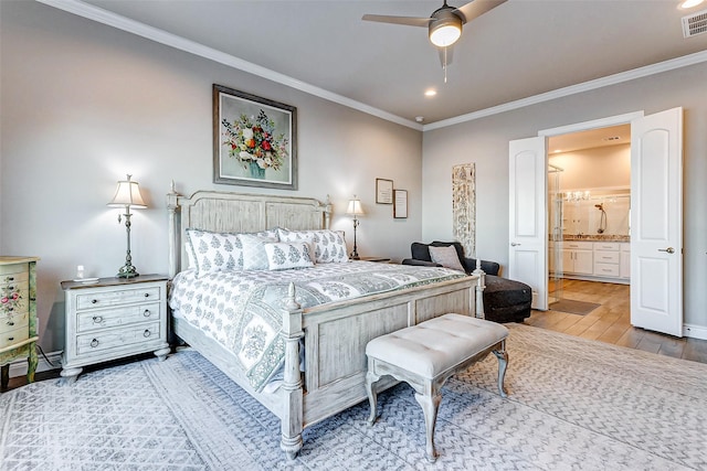 bedroom with hardwood / wood-style flooring, crown molding, connected bathroom, and ceiling fan