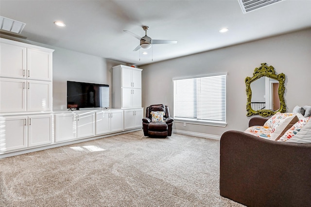 carpeted living room with ceiling fan