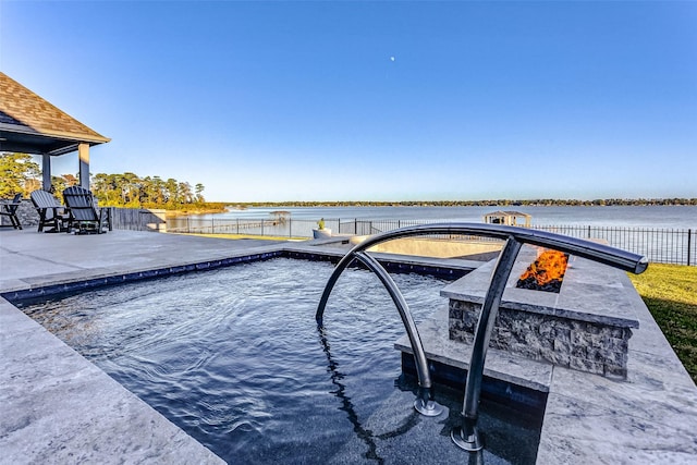 view of pool featuring a patio area and a water view