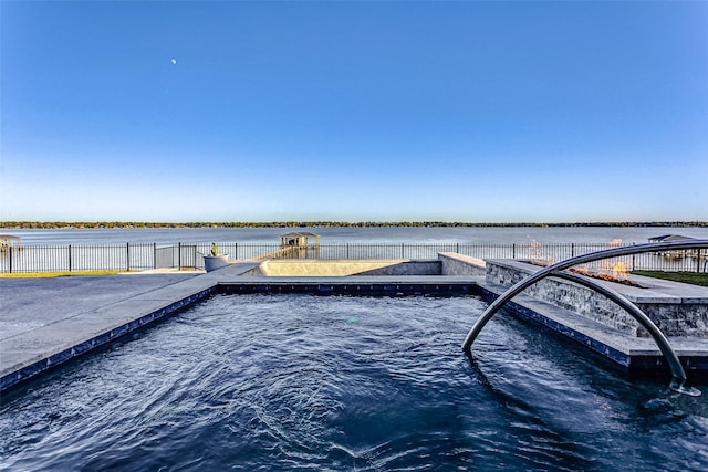 view of swimming pool featuring a playground and a water view