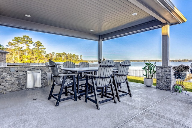 view of patio / terrace featuring a water view and area for grilling