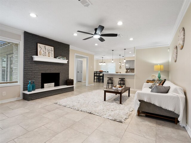 tiled living room with ceiling fan, a wealth of natural light, and ornamental molding