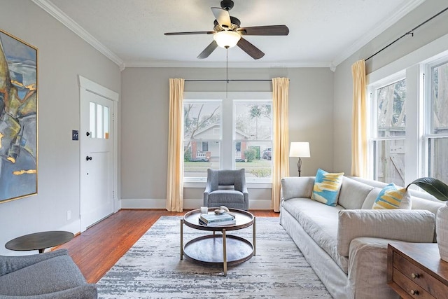 living room with wood-type flooring, plenty of natural light, crown molding, and ceiling fan