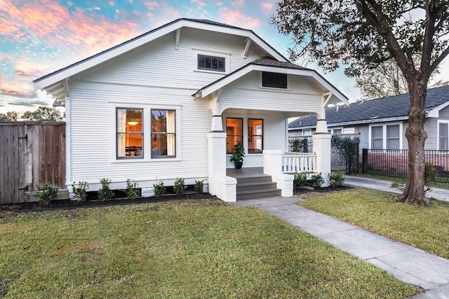 bungalow with a lawn and covered porch