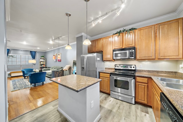 kitchen featuring sink, stainless steel appliances, crown molding, light hardwood / wood-style floors, and track lighting