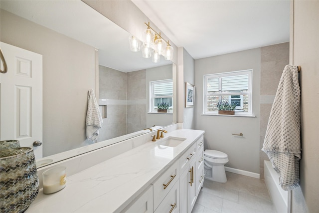 bathroom with toilet, vanity, and tile patterned flooring