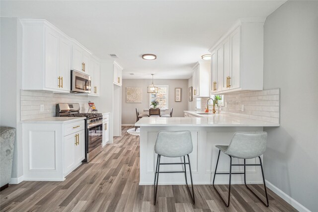 kitchen with white cabinetry, tasteful backsplash, and appliances with stainless steel finishes