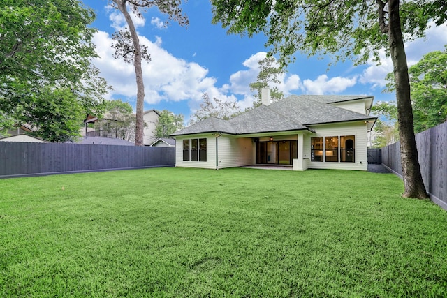 back of house featuring a yard