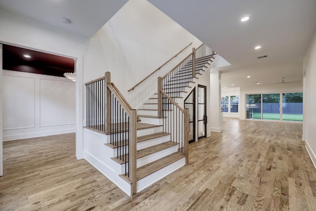 stairway with hardwood / wood-style flooring