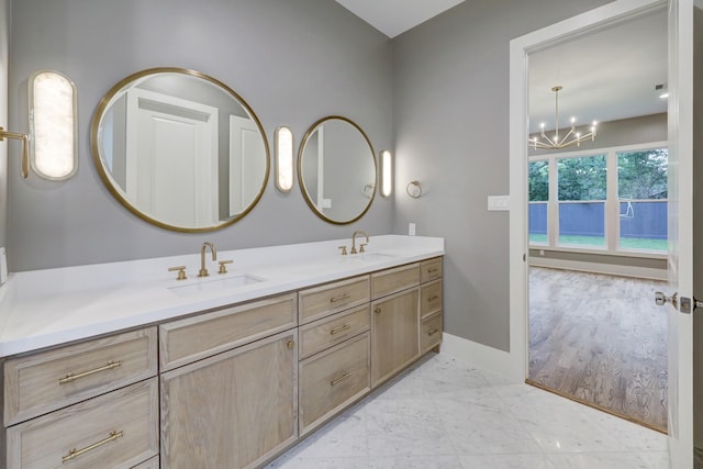 bathroom with vanity and an inviting chandelier