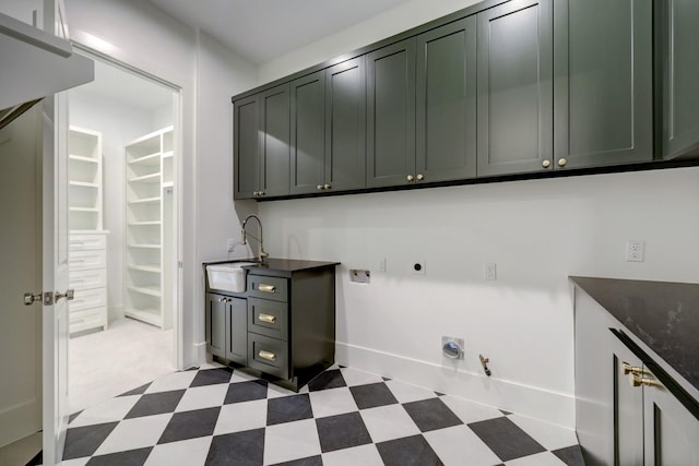 laundry room featuring electric dryer hookup, cabinets, hookup for a gas dryer, sink, and washer hookup